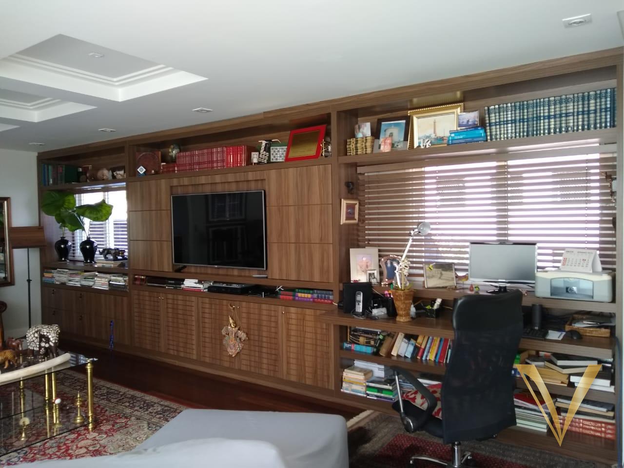Biblioteca com home office integrado, prateleiras e bancada de trabalho